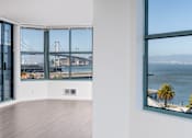 Thumbnail 64 of 95 - A room with a view of a bridge over the water.