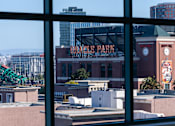 Thumbnail 66 of 95 - A view of a cityscape through a window with a building named Dodger Park visible.