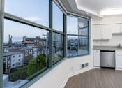 Thumbnail 74 of 95 - A kitchen with a large window overlooking a cityscape.
