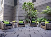 Thumbnail 10 of 95 - Four wicker chairs with green pillows are arranged on a patio.
