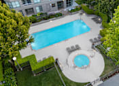 Thumbnail 83 of 95 - A swimming pool surrounded by a grassy area and trees.