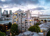 Thumbnail 95 of 95 - A cityscape with a bridge in the background and a building with a flag on top.