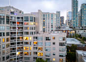 Thumbnail 94 of 95 - A cityscape with apartment buildings in the foreground and skyscrapers in the background.