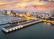 Thumbnail 93 of 95 - A marina filled with lots of boats at sunset.