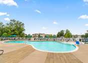 Thumbnail 15 of 30 - a swimming pool with chairs and umbrellas at the resort on a sunny day at Sycamore at Tyvola, Charlotte, 28217