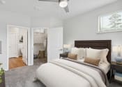 Thumbnail 11 of 54 - a bedroom with a large bed and a bathroom in the background at Two Addison Place Apartments , Georgia, 31322