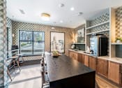 Thumbnail 25 of 28 - a kitchen with a long wooden table and a large window at Park and Kingston, Charlotte, NC
