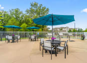 Thumbnail 17 of 30 - a patio with tables and chairs and umbrellas at Sycamore at Tyvola, Charlotte, NC