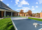 Thumbnail 26 of 41 - Outdoor ping pong table with building in background  at Westwinds Apartments, Annapolis MD