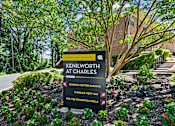 Thumbnail 20 of 20 - A sign for Kenilworth at Charles is displayed in front of a landscaped area.