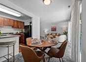 Thumbnail 3 of 20 - A modern dining room with a wooden table and chairs.