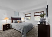 Thumbnail 12 of 20 - A bedroom with a bed, nightstand, and lamp.
