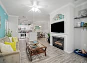 Thumbnail 18 of 42 - living room with sofa, coffee table and fireplace at The Grand Reserve at Tampa Palms Apartments, Tampa