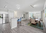 Thumbnail 3 of 42 - A kitchen with a dining table and chairs at The Grand Reserve at Tampa Palms Apartments, Tampa