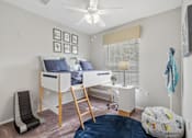 Thumbnail 11 of 42 - A room with a bunk bed and a chair at The Grand Reserve at Tampa Palms Apartments, Tampa, Florida