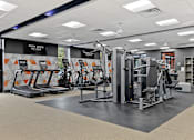 Thumbnail 23 of 26 - a gym with cardio machines and other exercise equipment at Doncaster Village Apartments, Parkville, Maryland