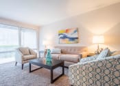 Thumbnail 3 of 12 - Light filled living room at Brook View Apartments, Baltimore, MD, 21209