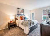 Thumbnail 5 of 12 - Bedroom with Balcony Access at Brook View Apartments, Baltimore, MD