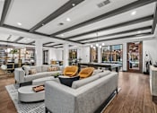Thumbnail 18 of 31 - A modern clubroom with a grey sofa and a coffee table. at 1010 Dilworth Apartments, Charlotte, North Carolina