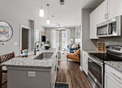 Thumbnail 2 of 31 - A modern kitchen with granite countertops and stainless steel appliances. at 1010 Dilworth Apartments, Charlotte