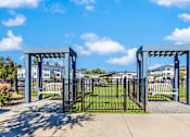 Thumbnail 13 of 21 - A gate with a blue arched top is in front of a grassy area.