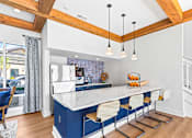 Thumbnail 17 of 21 - A kitchen with a white counter and blue cabinets.