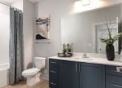 Thumbnail 7 of 15 - a bathroom with a toilet sink and a shower and a mirror at Bristol at New Riverside, Bluffton, SC