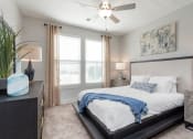 Thumbnail 5 of 15 - a bedroom with a large bed and a ceiling fan at Bristol at New Riverside, Bluffton, SC 29910