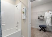 Thumbnail 8 of 15 - a bathroom with a tub and a shower and a towel rack at Bristol at New Riverside, South Carolina, 29910