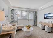 Thumbnail 6 of 9 - Light filled living room at Cross Country Manor Apartments, Baltimore, Maryland