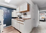 Thumbnail 10 of 23 - a kitchen with white cabinets and a sink and a refrigerator at Falls Village Apartments, Maryland