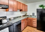 Thumbnail 6 of 16 - Kitchen with Black Appliances at Kenilworth at Charles Apartments, Towson, MD