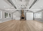 Thumbnail 18 of 20 - a large living room with a fireplace and wooden floors at McDonogh Township Apartments, Owings Mills