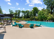 Thumbnail 19 of 31 - Swimming pool at Padonia village with splash pad and lounge seating at Padonia Village Apartments, Timonium, 21093