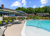 Thumbnail 18 of 31 - resort style swimming pool with apartments and community center in the background at Padonia Village Apartments, 21093