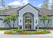 Thumbnail 42 of 42 - A white building with a fountain in front at The Grand Reserve at Tampa Palms Apartments, Tampa
