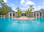 Thumbnail 26 of 42 - A large swimming pool in front of a house at The Grand Reserve at Tampa Palms Apartments, Florida, 33647
