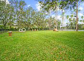 Thumbnail 33 of 42 - A park with a grassy area and a large sculpture in the middle at The Grand Reserve at Tampa Palms Apartments, Florida