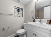 Thumbnail 10 of 31 - a white bathroom with a toilet and a sink at Padonia Village Apartments, Timonium, MD