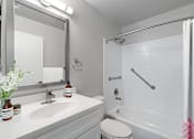 Thumbnail 4 of 23 - a bathroom with a sink toilet and bathtub at Falls Village Apartments, Baltimore MD