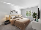 Thumbnail 4 of 31 - a bedroom with grey walls and a large bed  with a brown blanket at Padonia Village Apartments, Timonium MD