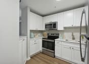 Thumbnail 1 of 27 - a kitchen with white cabinets and stainless steel appliances at The Bluestone Apartments, Bluffton, 29910