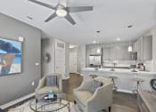 Thumbnail 6 of 38 - an open living room and kitchen with a ceiling fan at Central Island Square, South Carolina