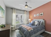 Thumbnail 7 of 38 - a bedroom with a bed and a ceiling fan at Central Island Square, Daniel Island, South Carolina
