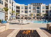 Thumbnail 12 of 38 - Pool with firepit lounge at Central Island Square, Daniel Island, SC, 29492