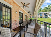 Thumbnail 24 of 25 - a patio with tables and chairs and a ceiling fan at Courthouse Square Apartments, Maryland, 21286
