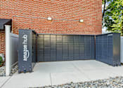 Thumbnail 23 of 25 - amazon hub package lockers in front of a brick building at Courthouse Square Apartments, Towson