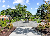 Thumbnail 19 of 25 - a patio with chairs and a fire pit at Courthouse Square Apartments, Towson, MD, 21286