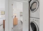 Thumbnail 13 of 25 - a small laundry room with a washing machine and a dryer at Courthouse Square Apartments, Maryland