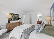 Thumbnail 6 of 25 - a white bedroom with a bed and a dresser at Courthouse Square Apartments, Maryland